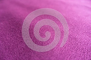 Close shot of magenta-colored faux suede fabric