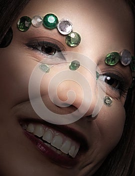 Close shot of model with jewels on face