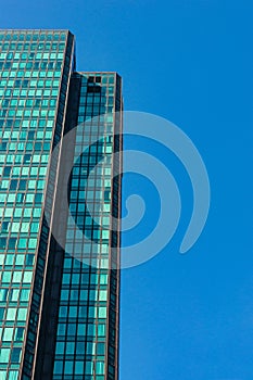 Close shot of a modern skyscraper with abstract reflections in it