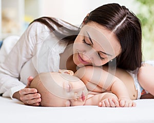 Close shot of a mother touching her sleeping newborn baby