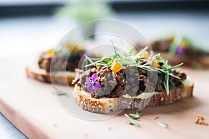 close shot of olive tapenade on a focaccia square