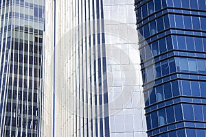 Close shot of a pair of twins corporate blue office buildings with a striped design.