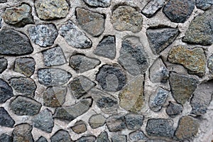 Close shot of wall with dark gray gravel pebbledash