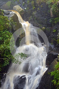 Close shot of a waterfall streaming from the mountain. Long exposure of a waterfall.