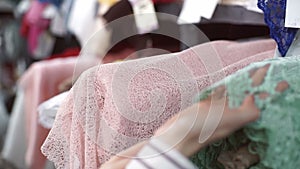 Close shot of woman hand verifies fabric store indoors