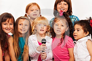 Close shots of kids singing