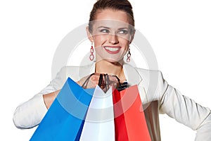 Close smiling woman with shopping bags looking aside