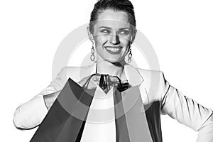 Close smiling woman with shopping bags looking aside