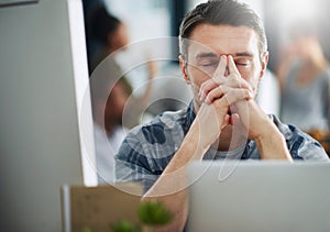 So close to breaking point...a mature businessman looking stressed out at his office desk.