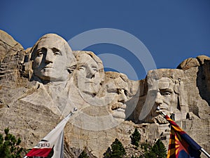 Close u, upward shot of the stone monuments of four US presidents at Mount Rushmore National