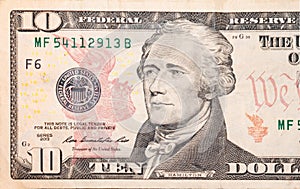 Close-up 10 US dollar banknotes, obverse ten dollar banknote depicting portrait American statesman Alexander Hamilton.