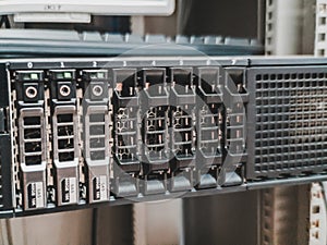 Close up of 2.5 inches hard drives bay in front of a working rack server.