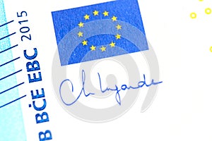 Close-up of a 20 euro banknote fragment with the flag of the European Union and the signature of the president of the ECB.