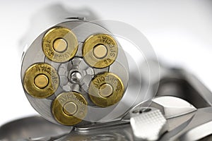 Close up of .38 special Bullets in revolver gun on white background