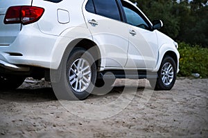 Close up 4x4 off road car vehicle standing on the sandy surface in beach with trailer d