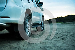 Close up 4x4 off road car vehicle standing on the sandy surface in beach with trailer d