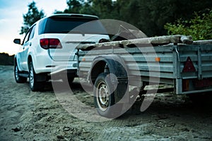 Close up 4x4 off road car vehicle standing on the sandy surface in beach with trailer d