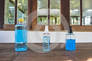 Close-up of 70% Blue Ethyl alcohol in different packages , spray bottle, plastic bottle and gel bottle, for coronavirus protection