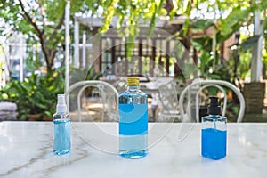 Close-up of 70% Blue Ethyl alcohol in different packages , spray bottle, plastic bottle and gel bottle, for coronavirus protection