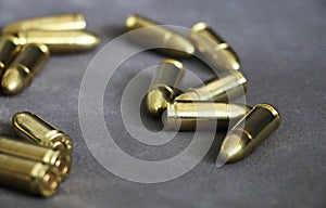 Close up of 9 mm golden pistol bullets ammo on background