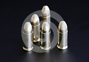 Close up of 9 mm golden pistol bullets ammo on background