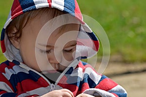 Close-up of a 9 month old baby exploring nature