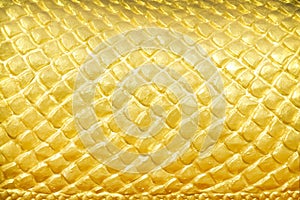 Abstract gold yellow serpent scale statue texture with seamless patterns for background