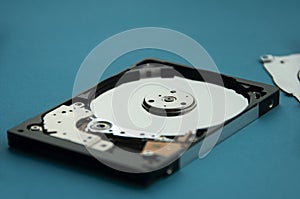 Close up of abstract image of inside of hard disk drive on blue cover background. Concept of data, hardware, and