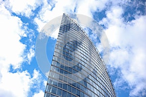 Close up abstract modern skyscraper architecture tall glass building with clouds in background