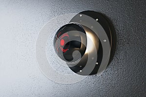 Close up of abstract round black cctv camera on concrete wall background. Safety system and security concept.