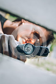 Close-up abstract view of attractive female army soldier with gun