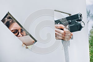 Close-up abstract view of attractive female army soldier with gun