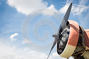Close up abstract of a vintage airplane propeller engine against blue sky, closeup. Travel concept