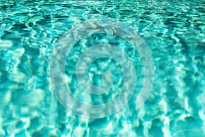 Close up abstract water texture. Turquoise swimming pool water background. Copy space, top view.