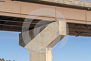 Close up of the abutment supporting the span of a beam bridge on a sunny day