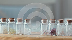 Close-up of accessories for jewelry and jewelry in transparent jars.