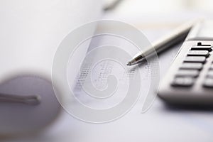 Close-up of accounting tools lying on statement