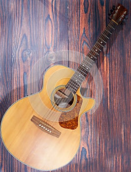 Close up of acoustic guitar. Acoustic guitar against an old wooden background
