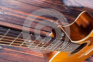 Close up of acoustic guitar. Acoustic guitar against an old wooden background