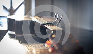 Close-up of an acoustic guitar on a blurred background.