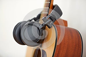 close up of acoustic guitar and headphones