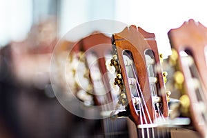 Close up of acoustic guitar necks on blurry background.