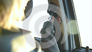 Close-up of action girl fastens a seat belt in a car before dropping off. Safe driving concept