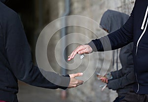 Close up of addict buying dose from drug dealer