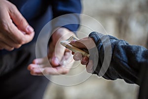 Close up of addict buying dose from drug dealer photo