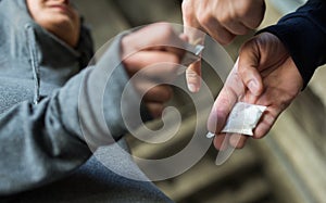 Close up of addict buying dose from drug dealer