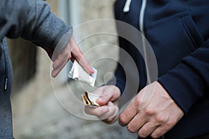 Close up of addict buying dose from drug dealer