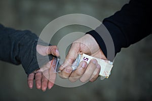 Close up of addict buying dose from drug dealer