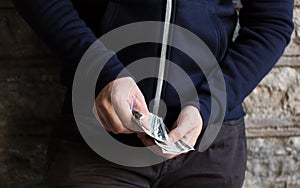 Close up of addict or drug dealer hands with money