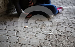 Close up of addict woman and drug syringes